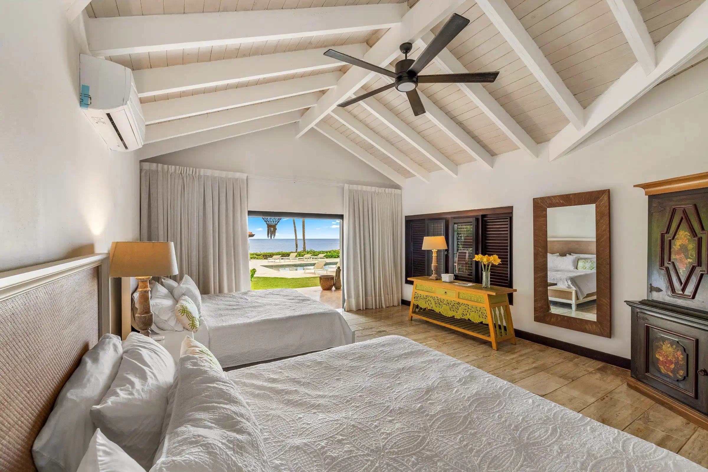 Bedroom at Costa Verde 3 looking through open doors to palms and the Caribbean