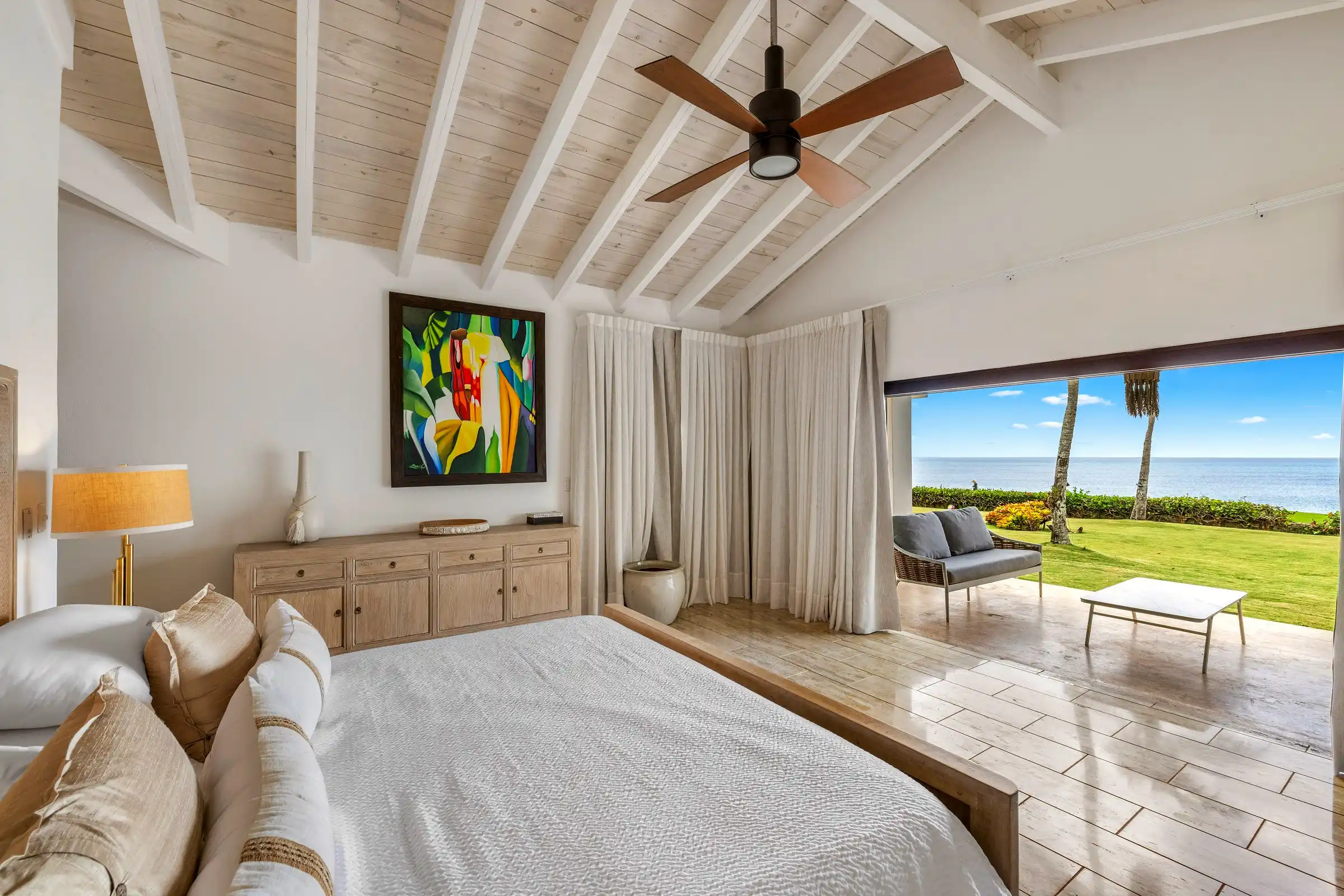 Bedroom at Costa Verde 3 opening onto the lawn with the flat blue of the Caribbean on the horizon