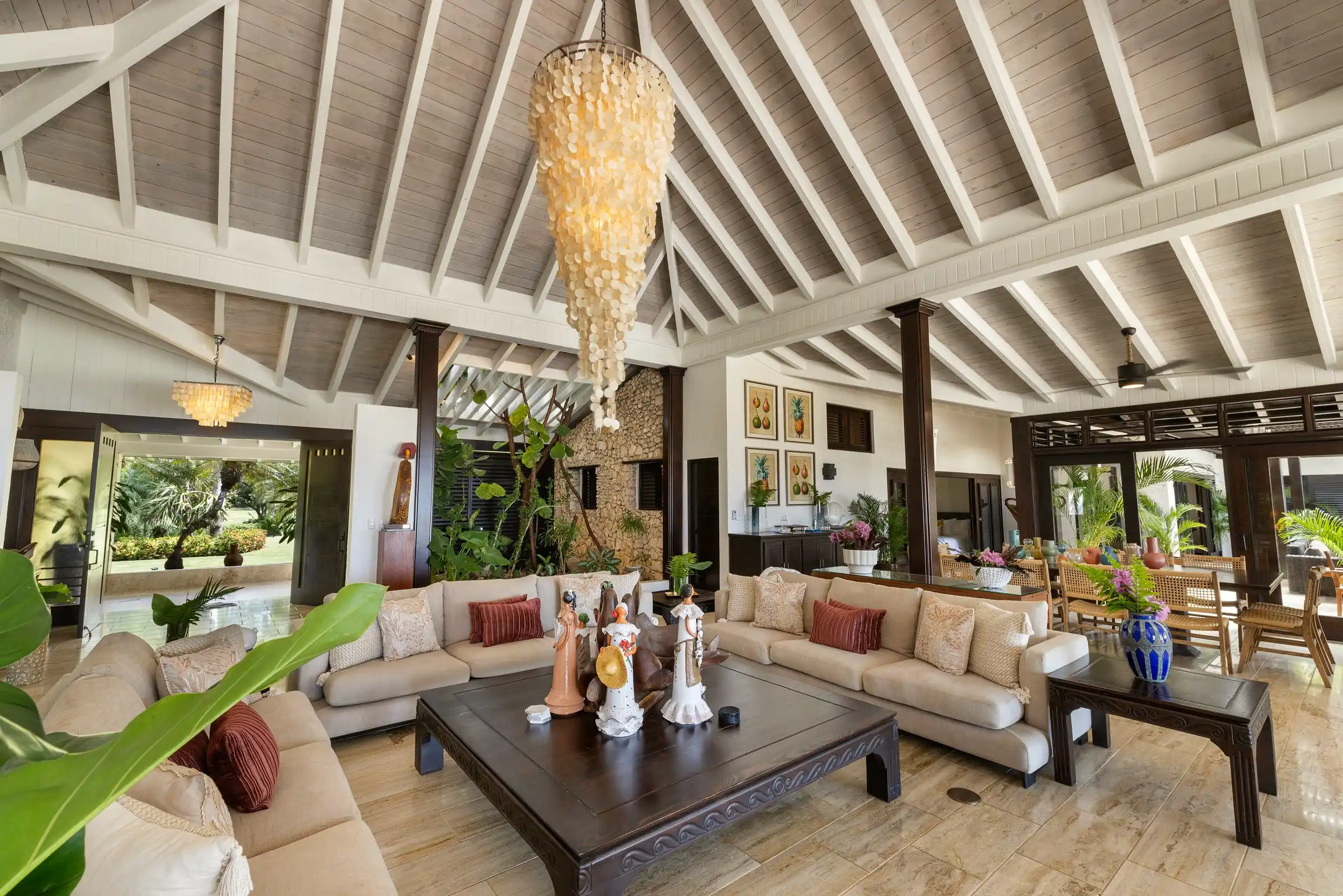 The central salon at Costa Verde 3, deep sofas beneath a white-beamed cathedral ceiling