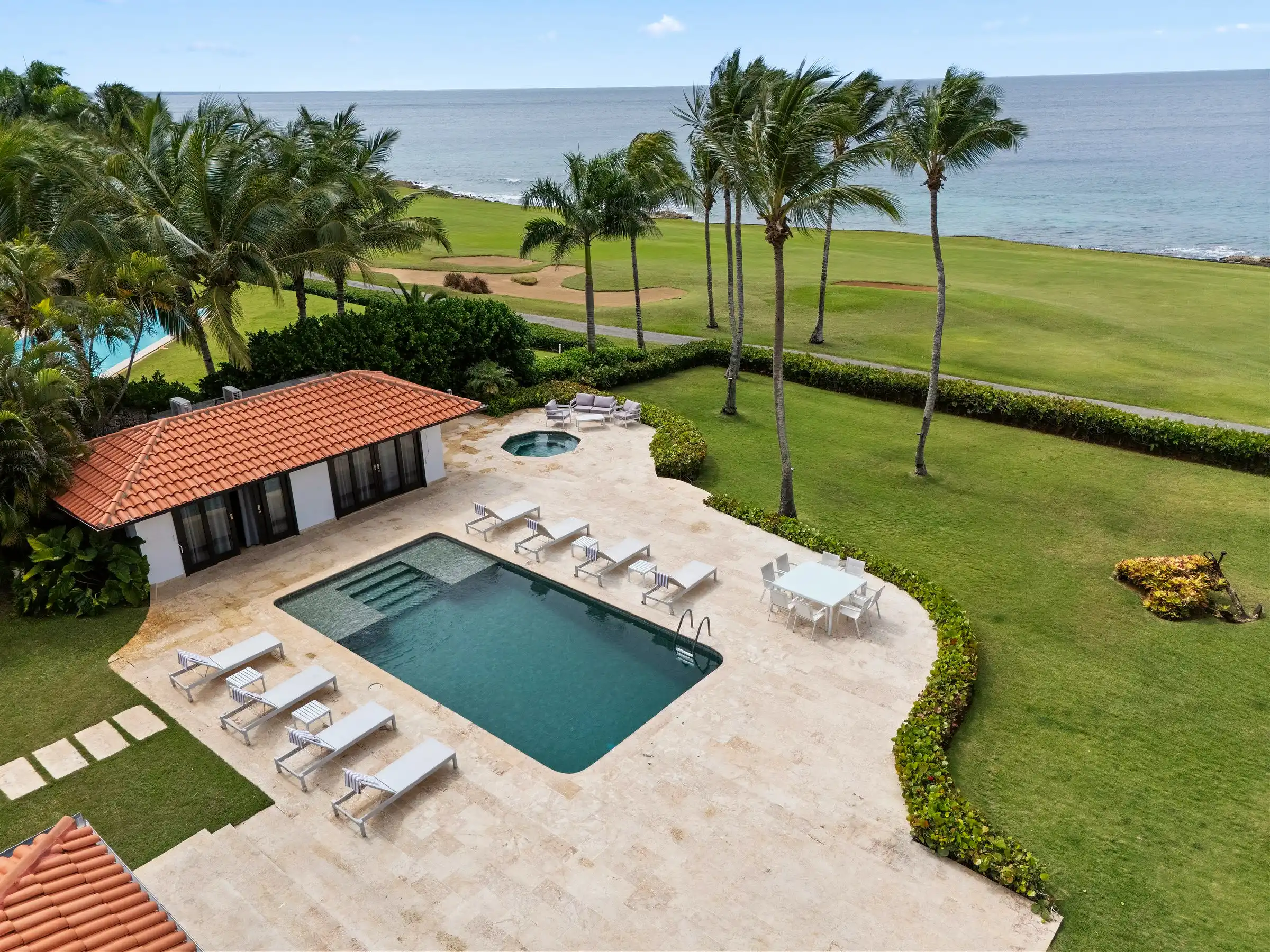 Elevated aerial placing Costa Verde 3 within the gated Casa de Campo resort, with the golf course and Caribbean beyond