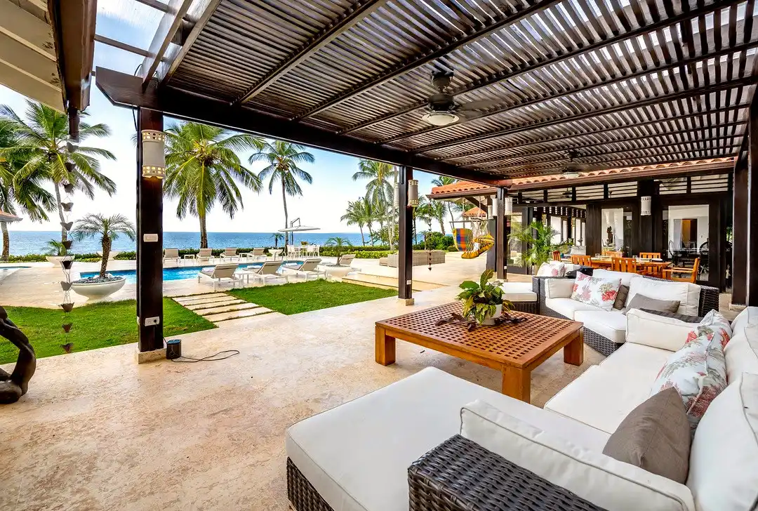 Covered lounge at Costa Verde 3 opening directly onto the pool terrace and the sea