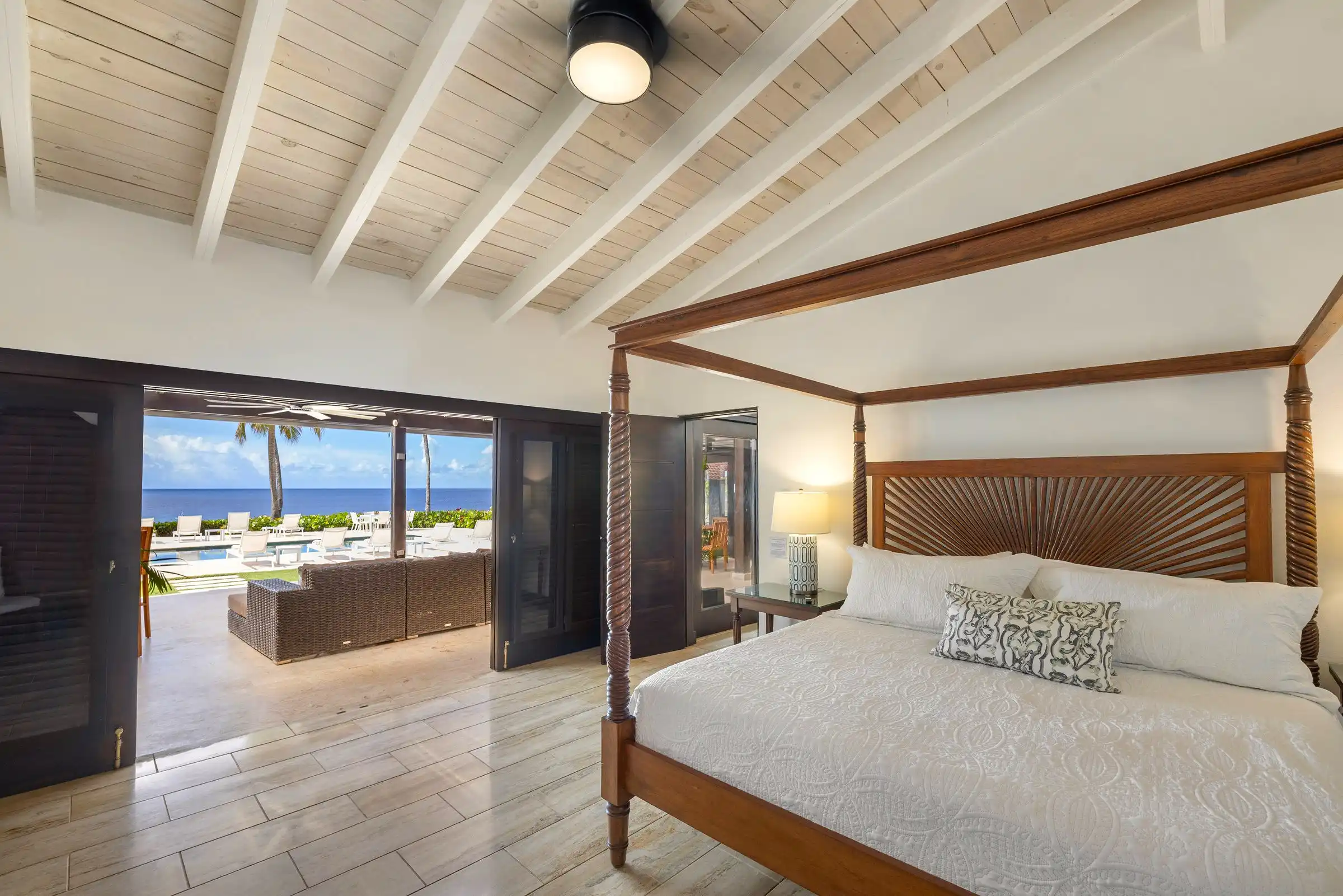Four-poster bedroom at Costa Verde 3 looking out to the pool terrace and the sea
