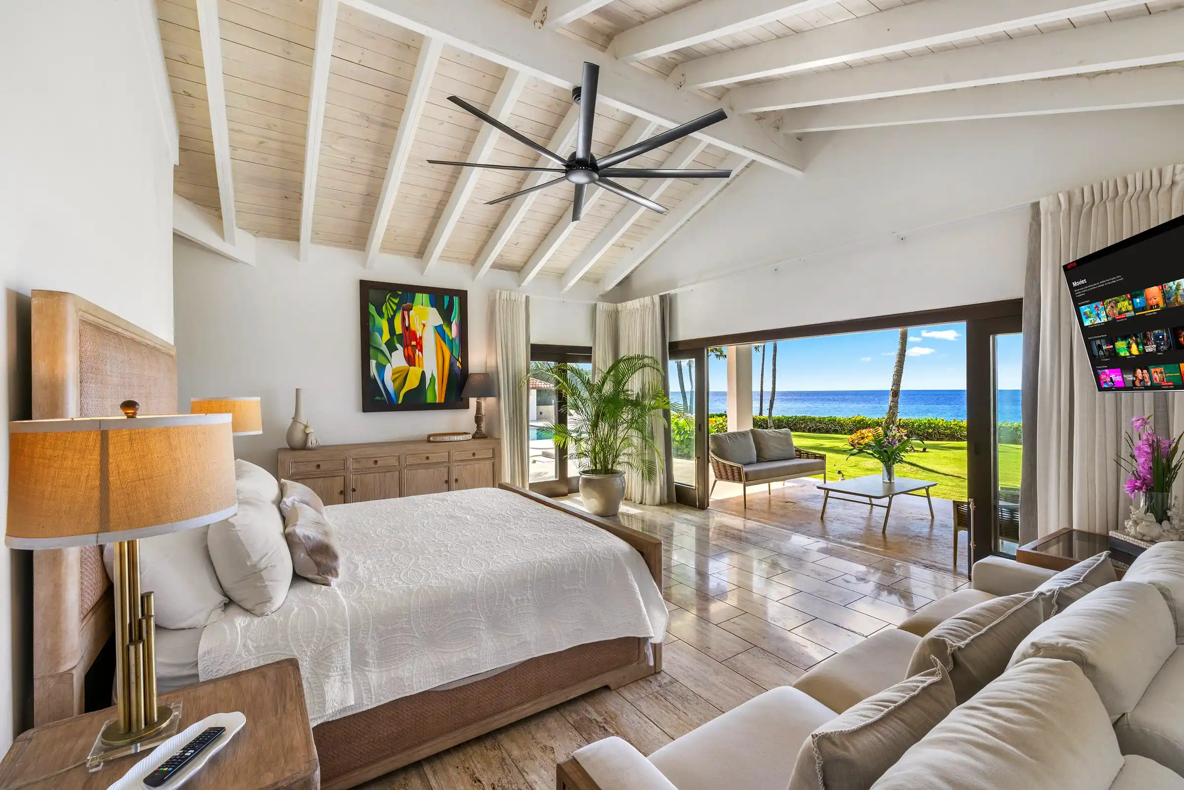 Guest bedroom at Costa Verde 3 with its own sitting area and doors opening to the sea