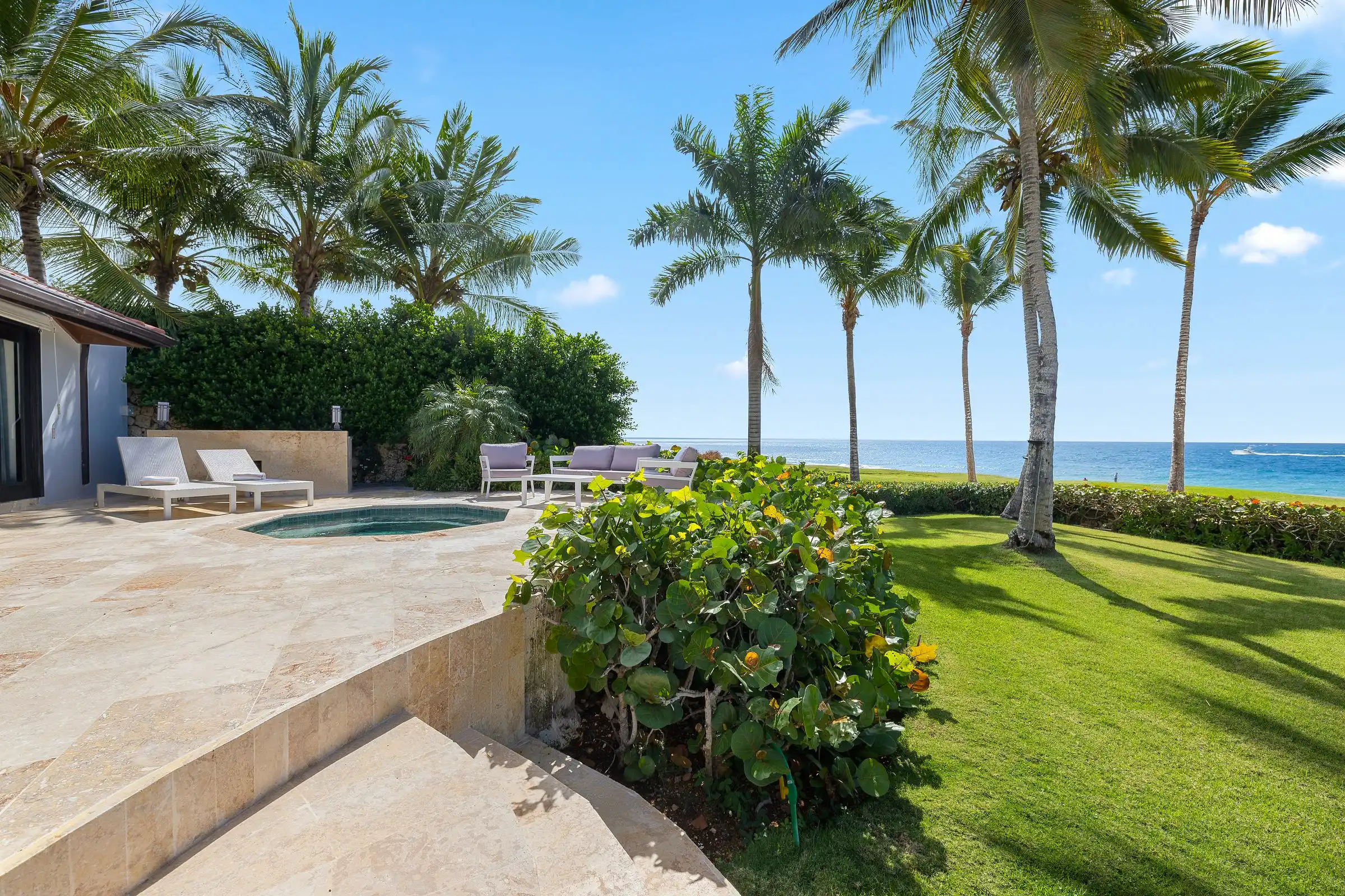 Manicured lawn and palms at Costa Verde 3 running down to the Caribbean horizon