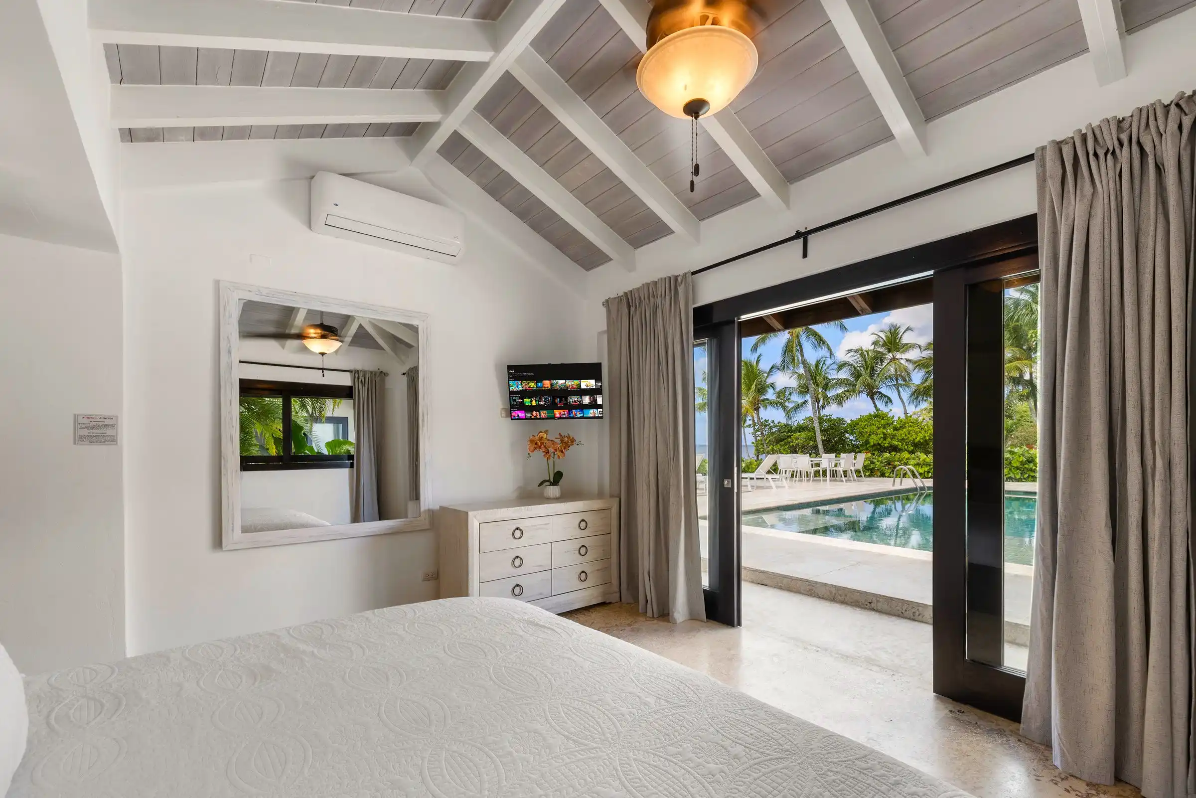 Bedroom at Costa Verde 3 opening through glass doors onto the plunge pool and terrace