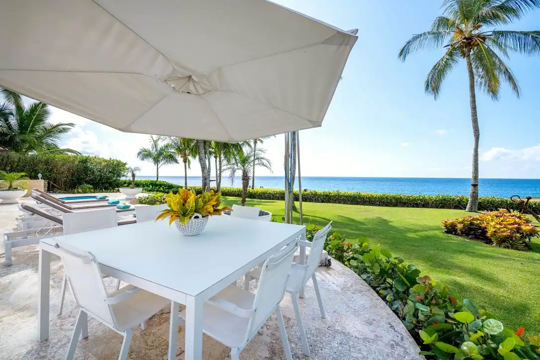 Shaded sea-facing dining terrace at Costa Verde 3 beneath a parasol