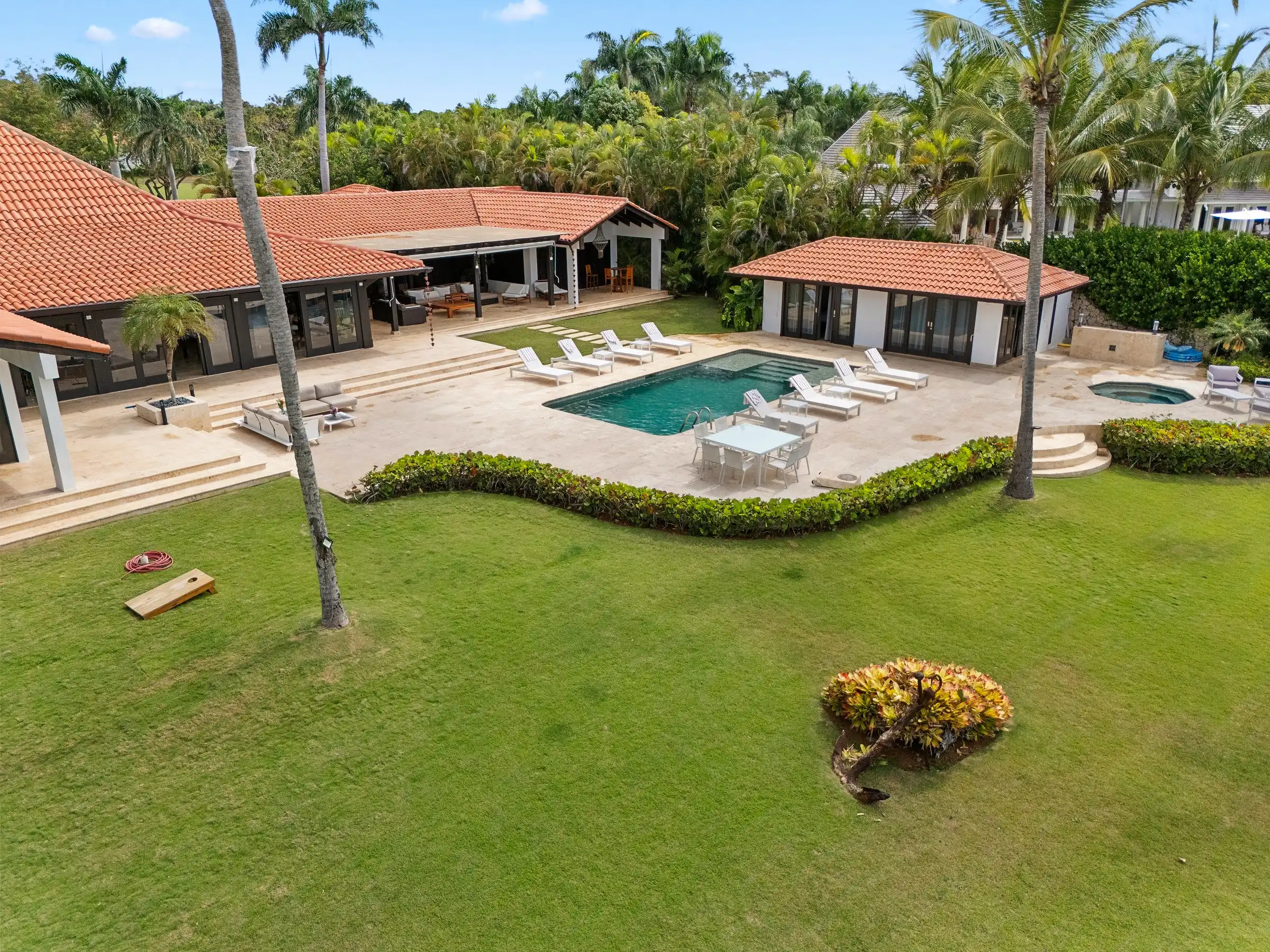 Aerial of the villa, poolhouse and open lawns of Costa Verde 3 running toward the Caribbean at Casa de Campo